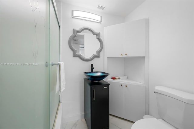 full bathroom featuring tile floors, toilet, vanity, and shower / bath combination with glass door