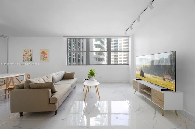 tiled living room featuring track lighting