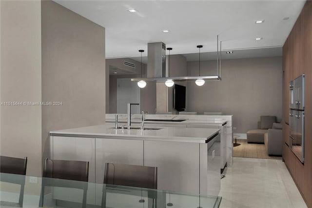 kitchen featuring light tile patterned flooring, sink, and pendant lighting