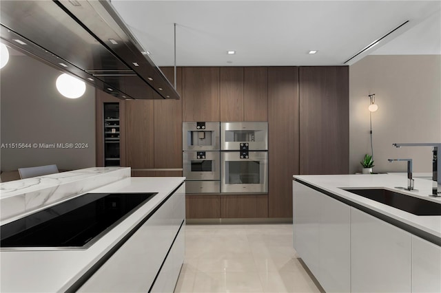 kitchen with stainless steel double oven, premium range hood, light tile patterned floors, sink, and black electric stovetop