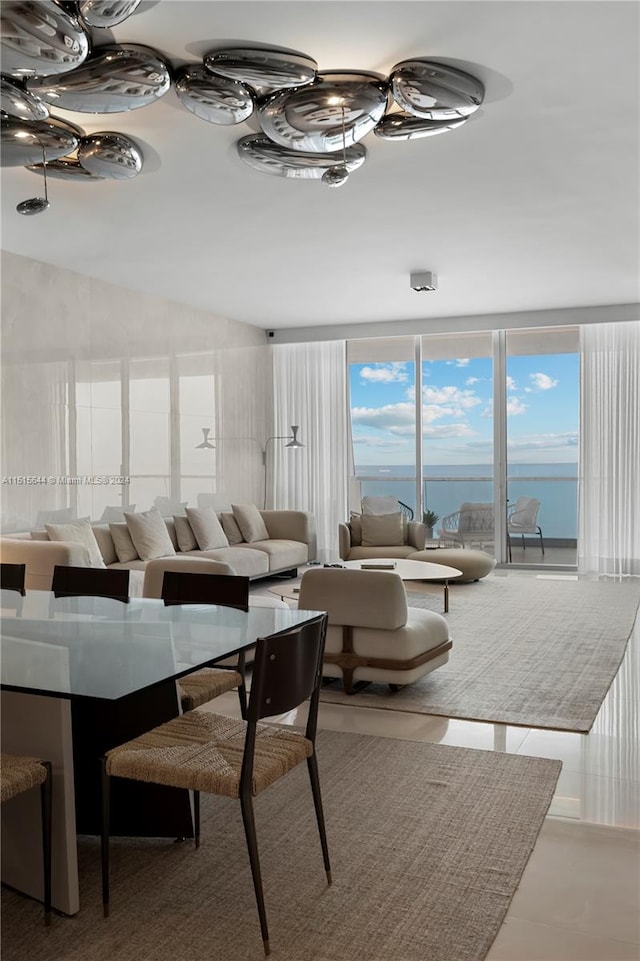 dining area featuring a water view and vaulted ceiling