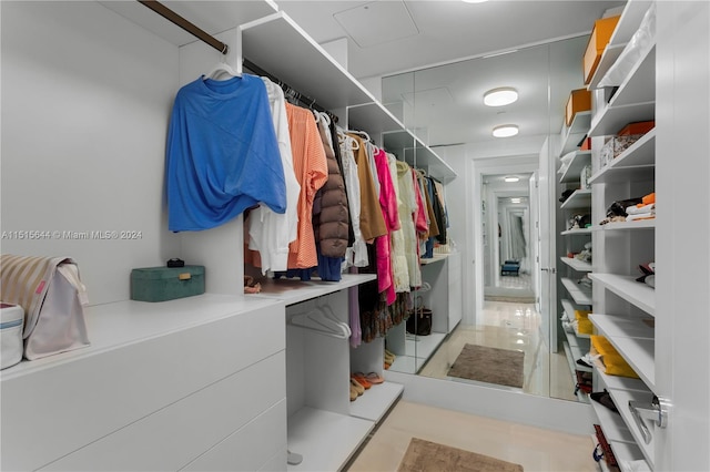 spacious closet featuring light tile patterned floors