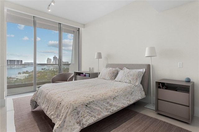 bedroom with a water view and rail lighting