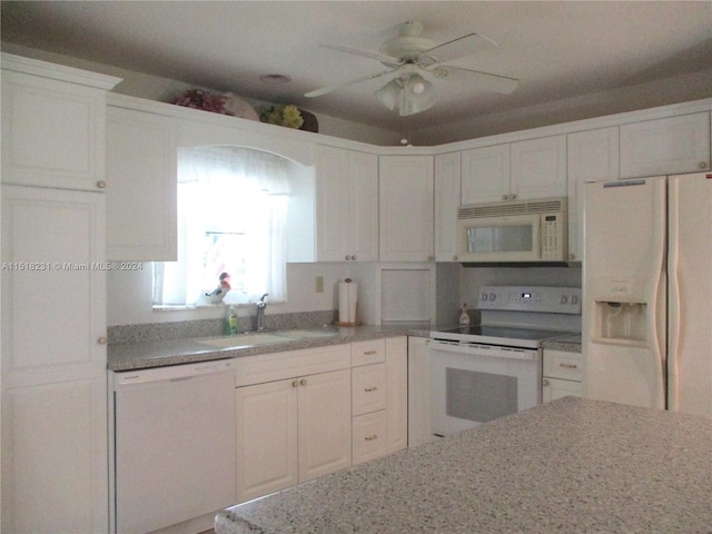 kitchen with ceiling fan, sink, white appliances, and white cabinets