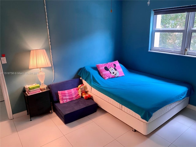 bedroom featuring tile patterned flooring and baseboards