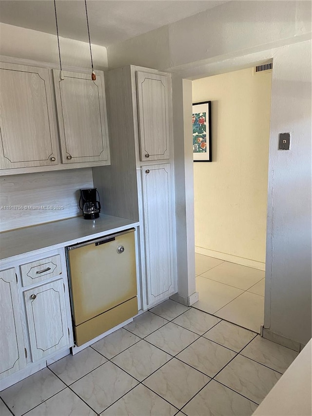 kitchen featuring dishwashing machine, visible vents, and light countertops