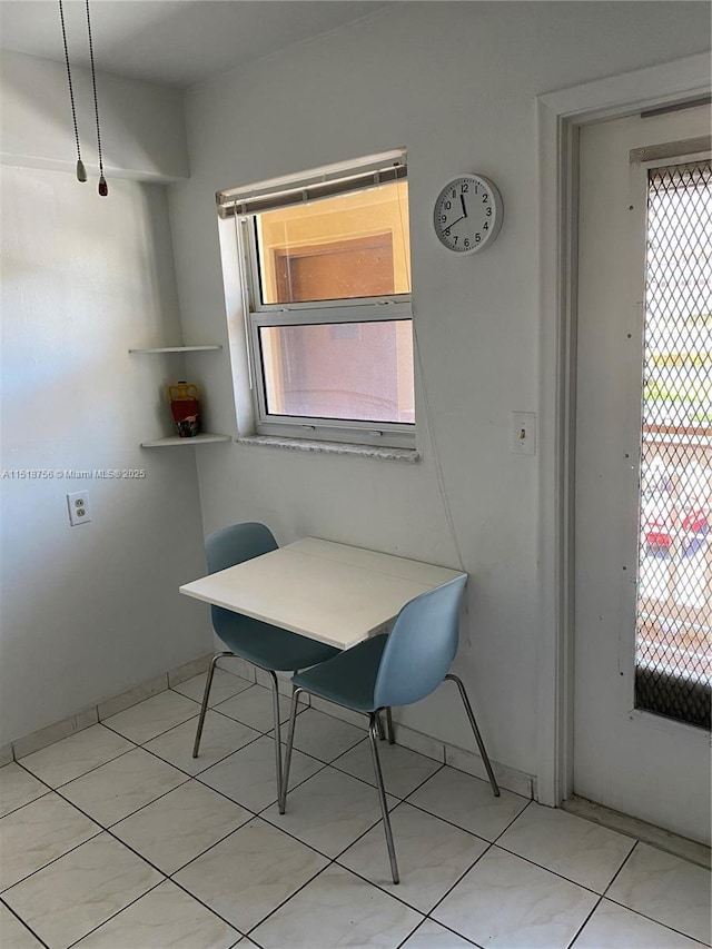 dining area featuring light tile patterned floors