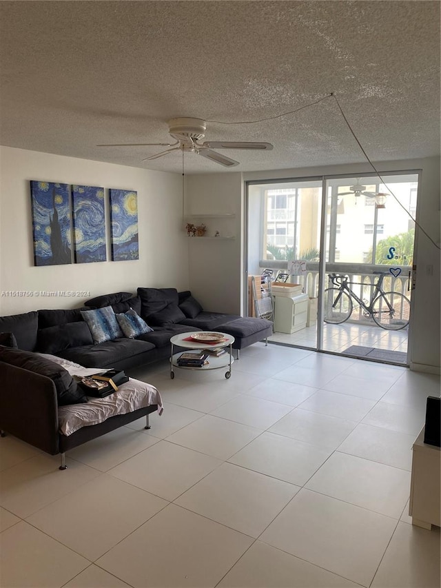 living area featuring a textured ceiling, a ceiling fan, and tile patterned floors