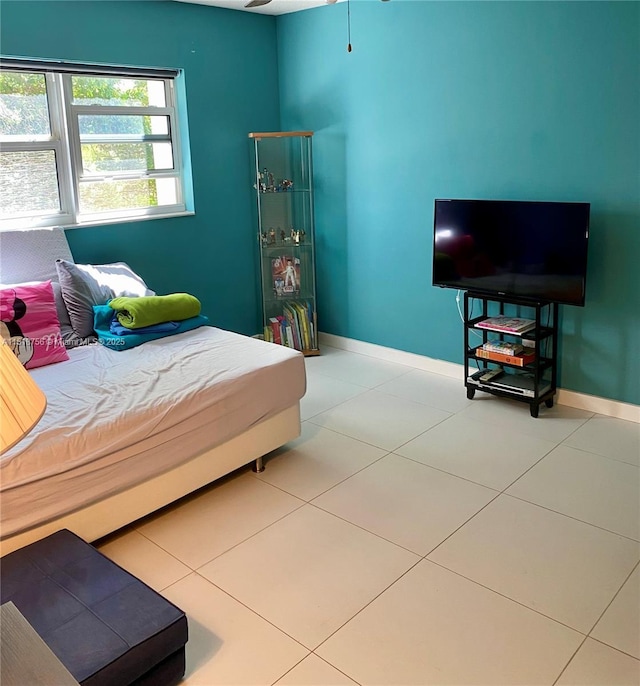 bedroom featuring tile patterned flooring and baseboards