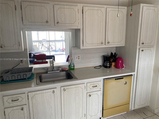 kitchen with dishwasher, light countertops, and a sink