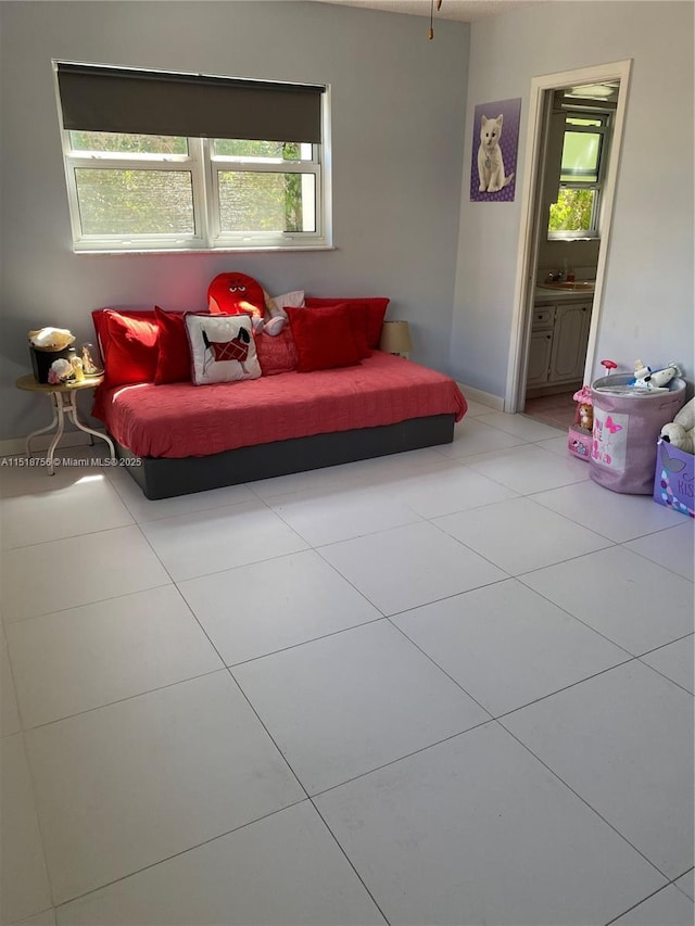 living room with a wealth of natural light and tile patterned flooring