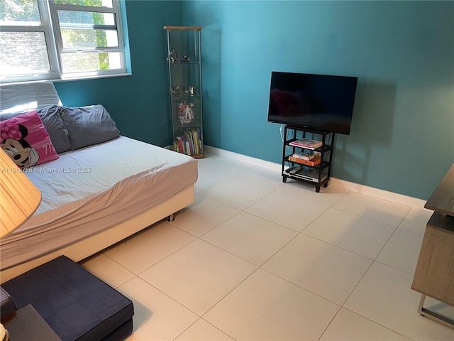 bedroom featuring tile patterned flooring and baseboards