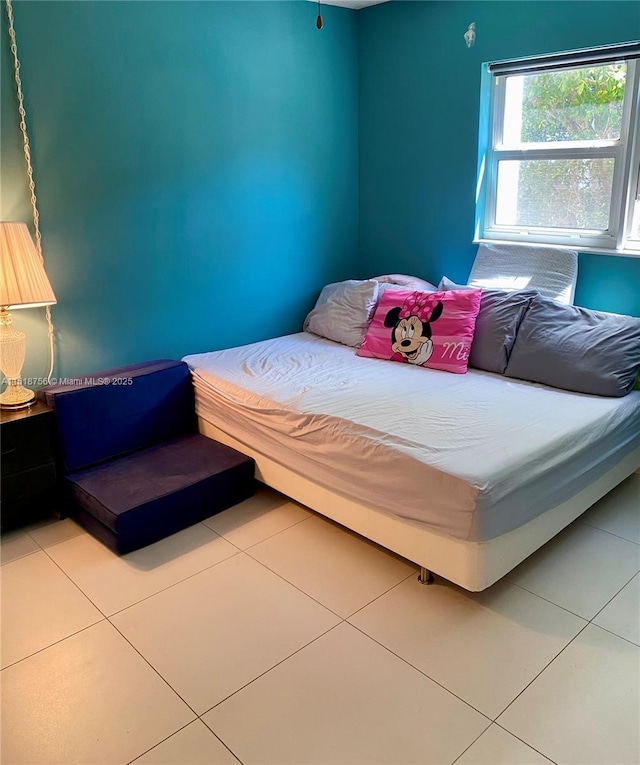 bedroom with light tile patterned flooring