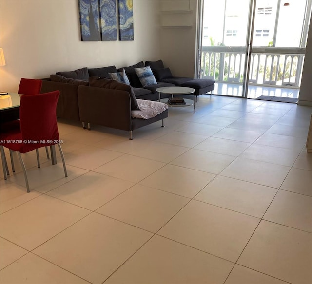 tiled living area featuring floor to ceiling windows