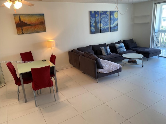 tiled living area featuring ceiling fan and baseboards