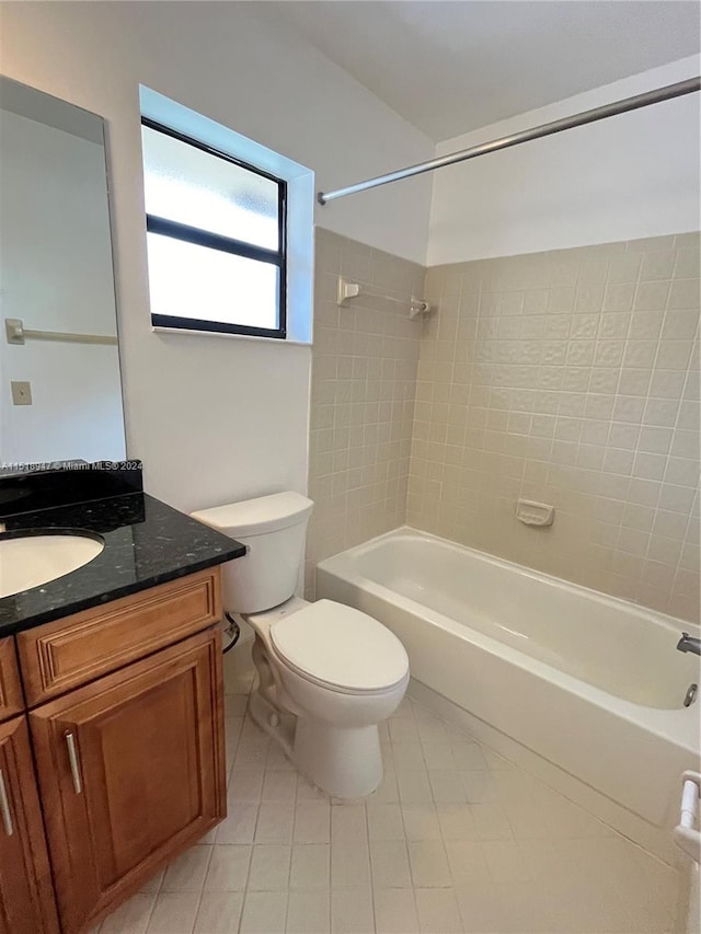 full bathroom featuring toilet, tile flooring, tiled shower / bath combo, and vanity