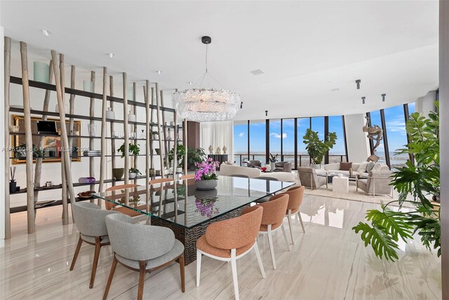 dining area with expansive windows and a chandelier