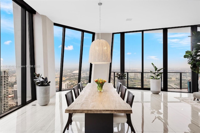 dining area featuring a wall of windows