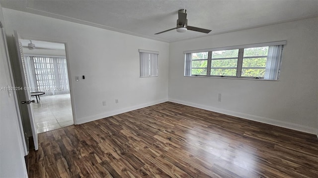 spare room with dark hardwood / wood-style floors and ceiling fan