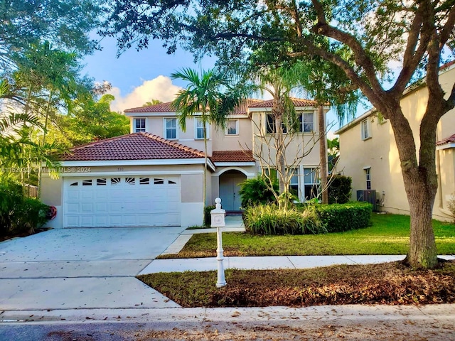 mediterranean / spanish-style house with central AC and a front lawn