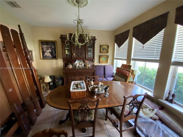 dining room with an inviting chandelier and light tile floors