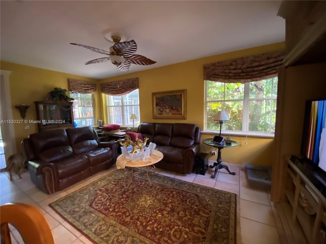 living room featuring light tile floors, ceiling fan, and a wealth of natural light