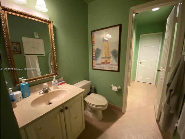 bathroom with toilet, tile flooring, and oversized vanity