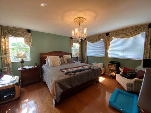 bedroom with a chandelier and hardwood / wood-style flooring