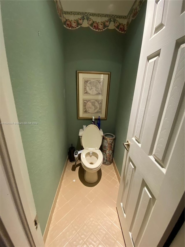 bathroom featuring toilet and tile flooring