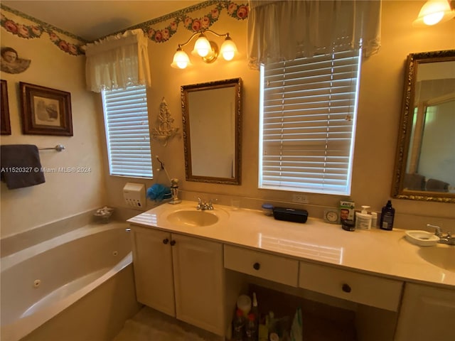 bathroom featuring double sink, a bath to relax in, and vanity with extensive cabinet space