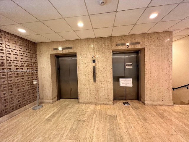 interior space with hardwood / wood-style floors and elevator