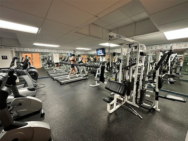 exercise room with a paneled ceiling