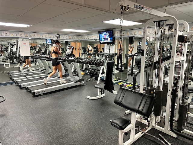 exercise room featuring a paneled ceiling