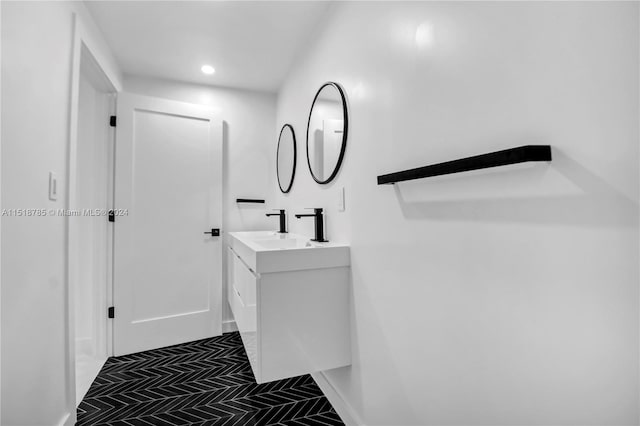 bathroom with tile flooring and vanity