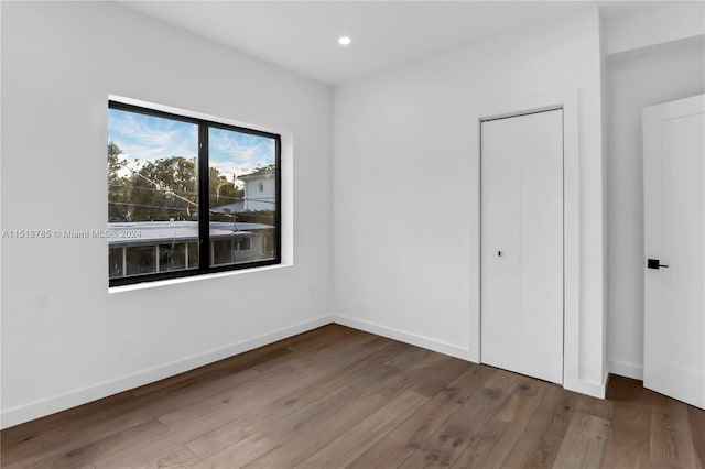 unfurnished bedroom featuring dark wood-type flooring