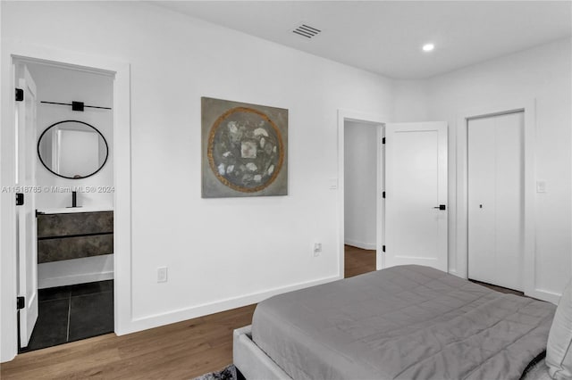 bedroom featuring tile floors and connected bathroom