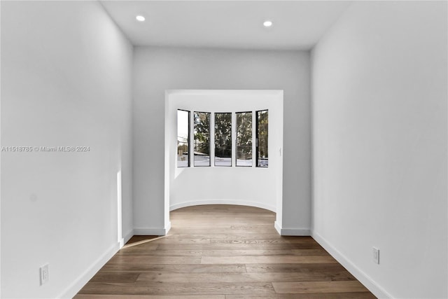 corridor with hardwood / wood-style floors