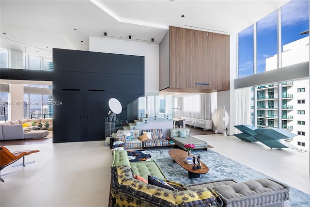 living room with light tile floors and a towering ceiling