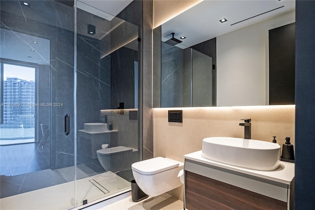 bathroom featuring tile walls, toilet, vanity, and a shower with shower door