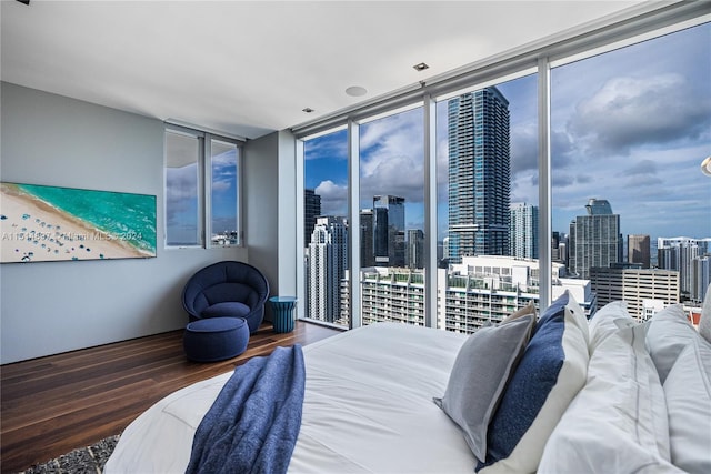 bedroom featuring floor to ceiling windows, access to outside, and dark hardwood / wood-style floors