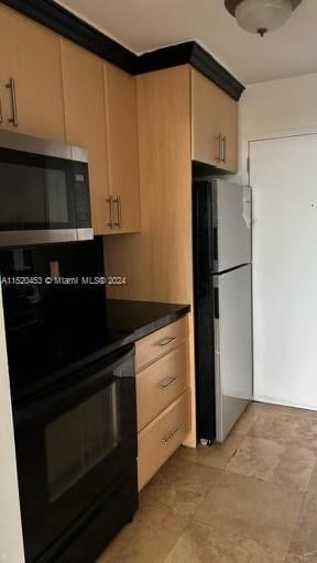 kitchen with light brown cabinetry, appliances with stainless steel finishes, and light tile floors