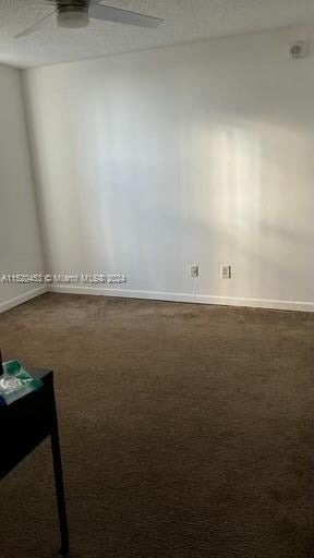 empty room with carpet flooring and ceiling fan