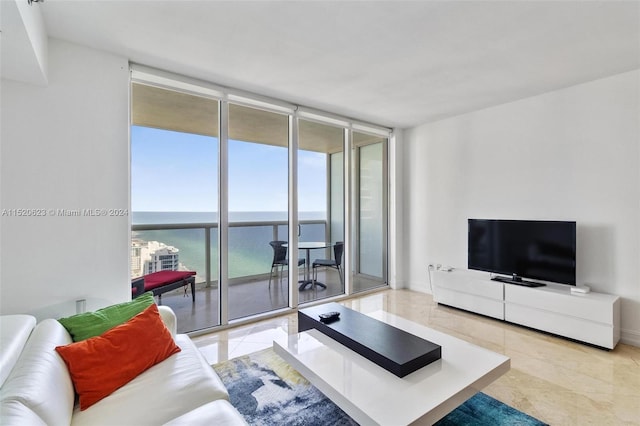 tiled living room with a water view and expansive windows