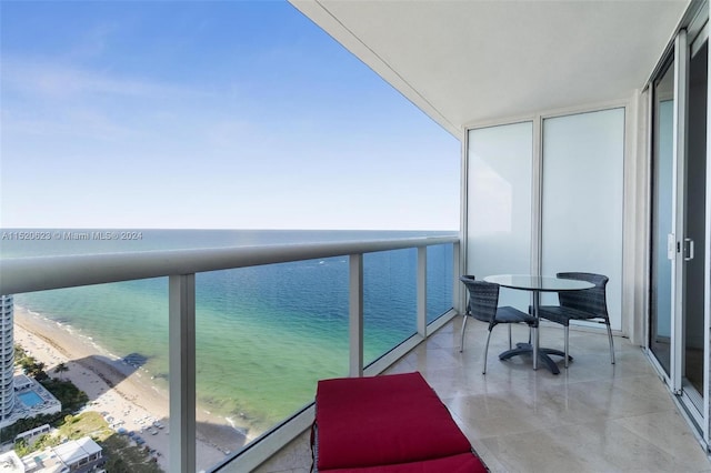 balcony with a view of the beach and a water view