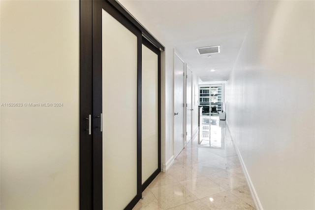 hallway featuring light tile floors