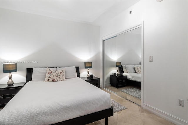 tiled bedroom with a closet