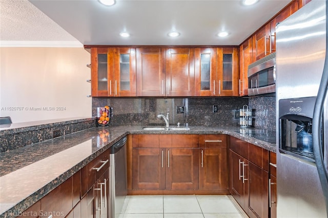 kitchen with stainless steel appliances, light tile floors, tasteful backsplash, ornamental molding, and sink