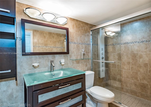 bathroom featuring vanity, toilet, and tile walls