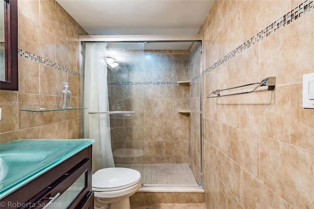 bathroom with tile walls, toilet, vanity, and tile flooring