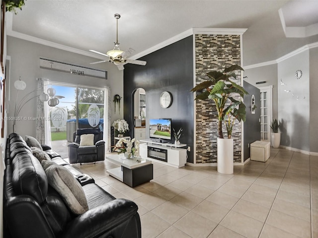 tiled living room with ceiling fan and ornamental molding